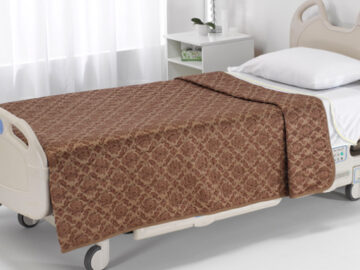 Picture of a brown color bedspread on a hospital bed